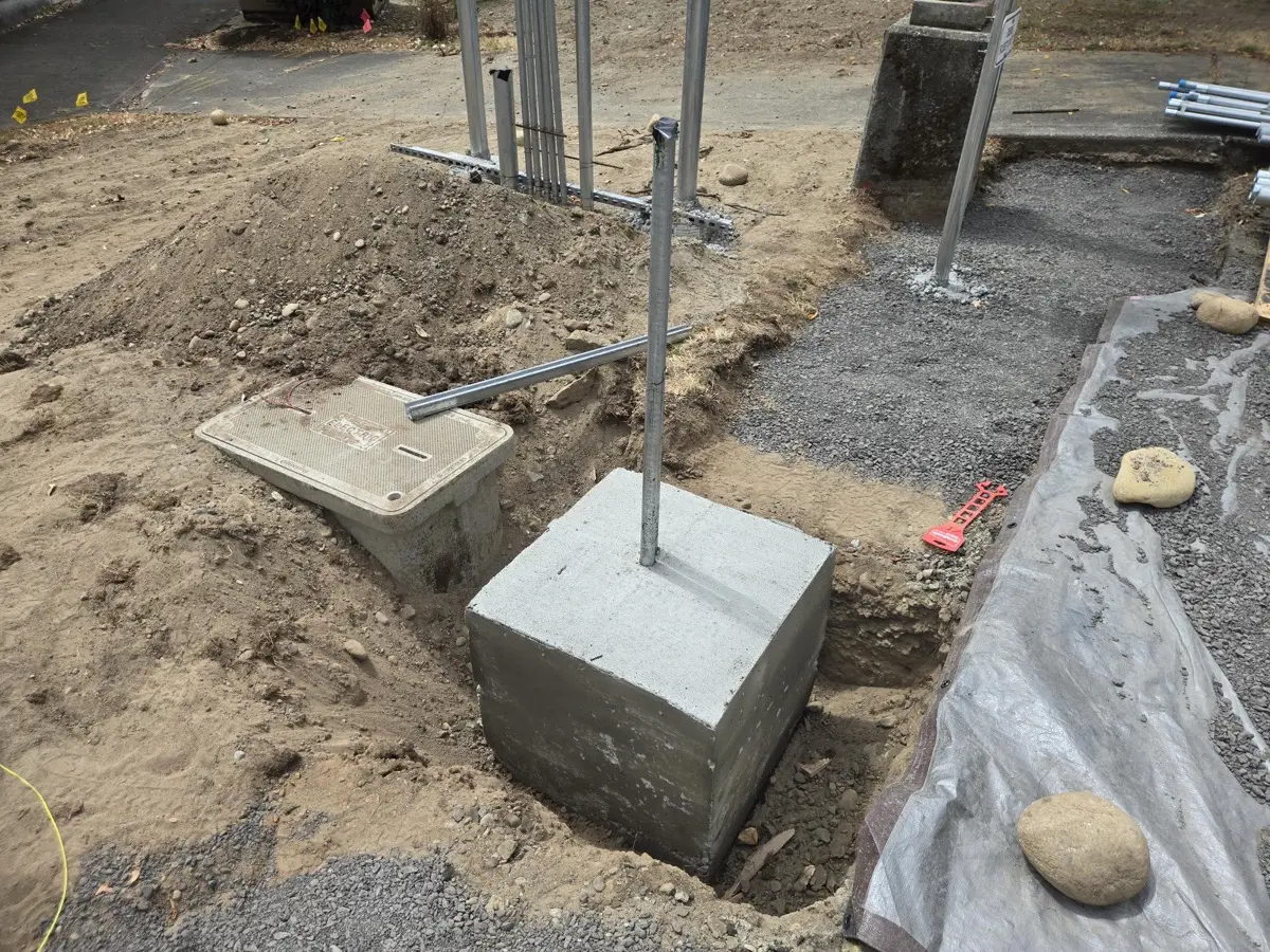 Concrete pedestal base with conduit stub-up for a charging station