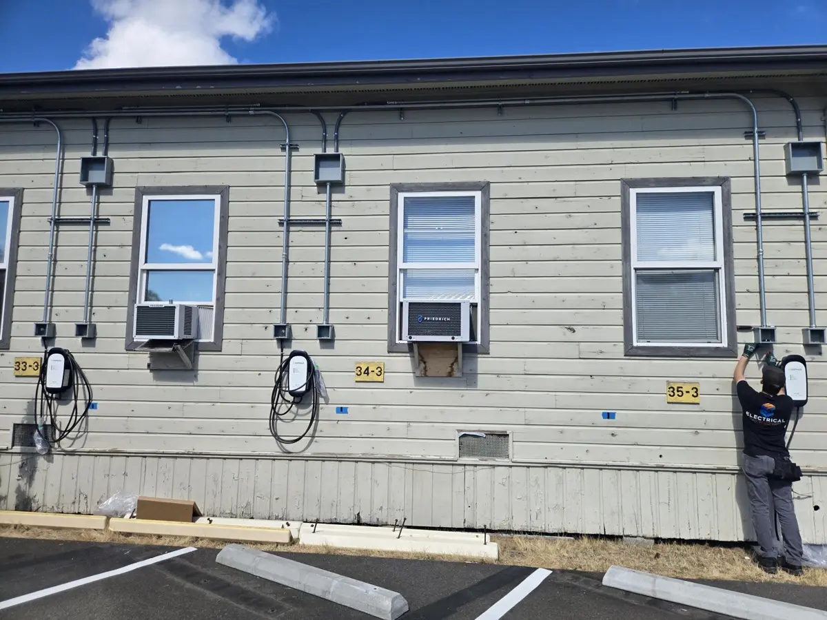 Electrical Support Company technician mounting wall-mounted EV chargers